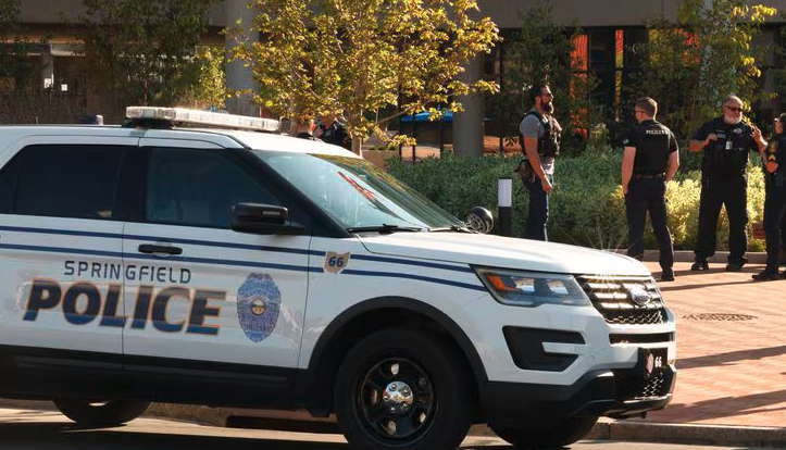 [Springfield and Dayton police officers outside the City Hall building following an evacuation due to a threat Thursday. Bill Lackey, staff photographer, Springfield News-Sun]